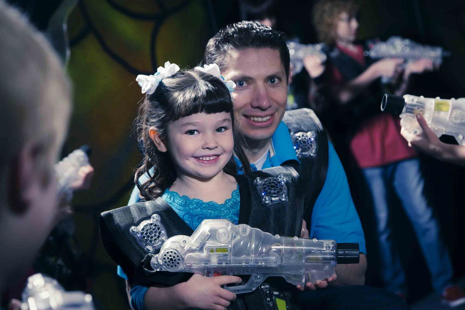 Dad and daughter playing laser tag together