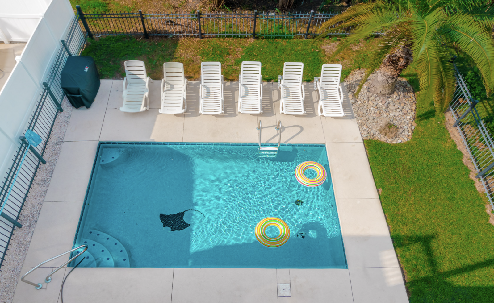 A private swimming pool of a garden city beach vacation rental