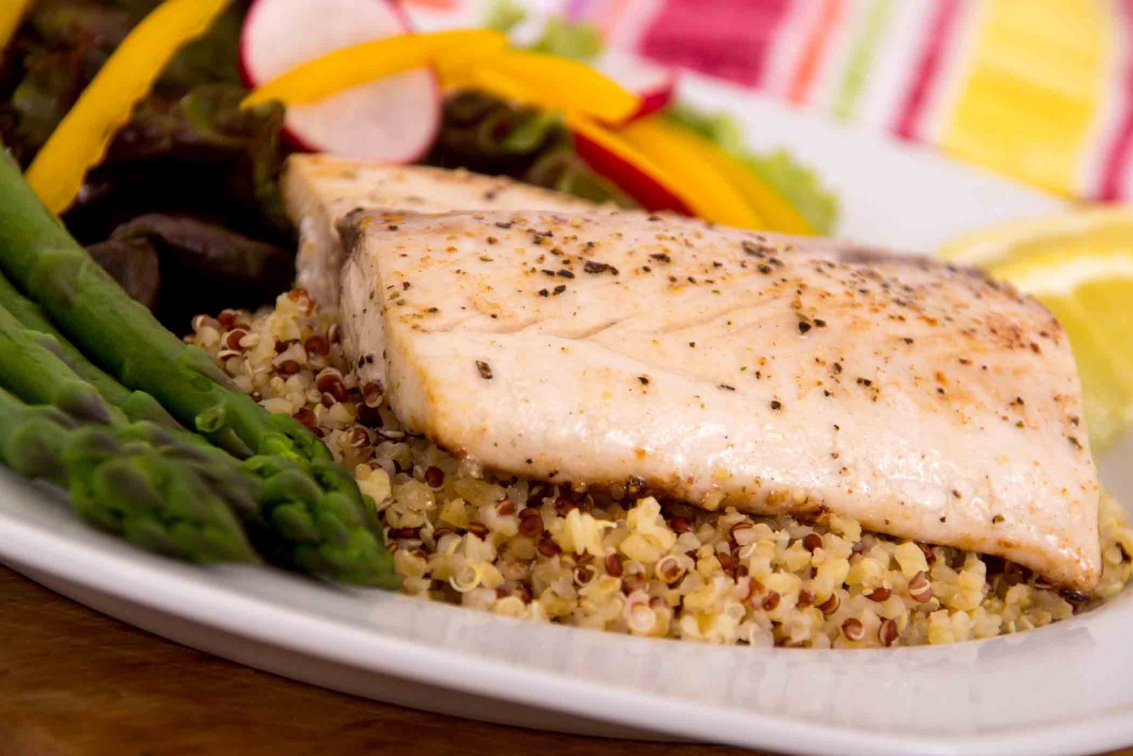 Fresh fish on a bed of quinoa with asparagus