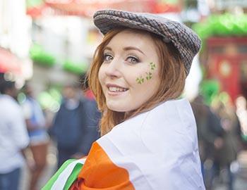 Irish girl smiling with clover face stickers