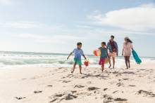 family happily running surfside beach